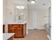 This bathroom features tile floors, wooden cabinets, bathtub, and a shower with a glass door at 249 Venice Way # 3301, Myrtle Beach, SC 29577