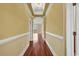 Hallway with decorative trim, wood flooring, and arched entryway to the living area at 249 Venice Way # 3301, Myrtle Beach, SC 29577