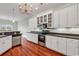 Modern kitchen featuring sleek white cabinets, stainless steel appliances, and hardwood flooring at 249 Venice Way # 3301, Myrtle Beach, SC 29577