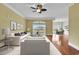 Staged living room with hardwood floors, modern sofa and a view of the dining area at 249 Venice Way # 3301, Myrtle Beach, SC 29577