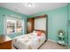 Bedroom featuring a charming murphy bed, a floral patterned quilt, and a window with natural light at 250 Ole Maple St., Loris, SC 29569