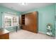 Bedroom with a murphy bed featuring built-in shelves, a pull-out desk, and a charming window view at 250 Ole Maple St., Loris, SC 29569