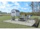 Backyard fire pit area with seating and a storage shed surrounded by a freshly mowed lawn at 250 Ole Maple St., Loris, SC 29569