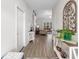 Bright hallway with wood floors, decorative tables, and a view into the living area at 250 Ole Maple St., Loris, SC 29569