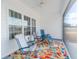 Inviting screened porch with a colorful rug, three chairs and view of the private backyard at 250 Ole Maple St., Loris, SC 29569