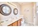 Bright bathroom featuring double sinks, decorative mirrors, and modern fixtures with tile flooring at 263 Burchwood Ln., Myrtle Beach, SC 29588