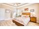 Warm primary bedroom with wood-style floors, tray ceiling, and natural light at 263 Burchwood Ln., Myrtle Beach, SC 29588