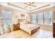 Bright primary bedroom with hardwood floors, tray ceiling, and natural light at 263 Burchwood Ln., Myrtle Beach, SC 29588