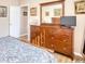 Bedroom featuring a dark wooden dresser, large mirror, and wood-style floors at 263 Burchwood Ln., Myrtle Beach, SC 29588