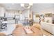 Inviting dining area and kitchen, boasting stainless appliances, a stone-countered island, and white cabinetry at 263 Burchwood Ln., Myrtle Beach, SC 29588