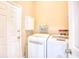 Bright laundry room features white washer and dryer and storage shelves at 263 Burchwood Ln., Myrtle Beach, SC 29588