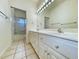 Bright bathroom featuring double sinks, a large mirror with Hollywood lights, and a shower at 270 Georgetown Dr., Pawleys Island, SC 29585