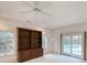 Bonus room with a wall of built-in shelving, carpet and a door leading to the pool at 270 Georgetown Dr., Pawleys Island, SC 29585