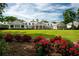 Sprawling clubhouse surrounded by lush green lawn, colorful flowers, and beautiful trees at 270 Georgetown Dr., Pawleys Island, SC 29585