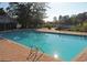 Outdoor community pool surrounded by brick pavers and lush trees at 270 Georgetown Dr., Pawleys Island, SC 29585