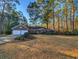 Charming brick home featuring an attached two-car garage, lush landscaping, and mature trees at 270 Georgetown Dr., Pawleys Island, SC 29585