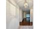 Hallway features tiled entry flowing to hardwood, leading to a light-filled room with French doors at 270 Georgetown Dr., Pawleys Island, SC 29585