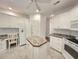 Kitchen features white cabinets, center island, desk area and tile flooring at 270 Georgetown Dr., Pawleys Island, SC 29585