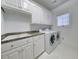 Clean laundry room featuring modern appliances, white cabinets and a sink at 270 Georgetown Dr., Pawleys Island, SC 29585