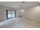 Bright living room with neutral carpet, ceiling fan, and glass doors to a patio at 270 Georgetown Dr., Pawleys Island, SC 29585