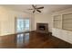 Living room with hardwood floors, fireplace, built-in shelving, and patio access at 270 Georgetown Dr., Pawleys Island, SC 29585