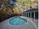 An inviting kidney shaped pool with brick surround and access to the screened in porch at 270 Georgetown Dr., Pawleys Island, SC 29585