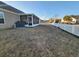 Spacious backyard featuring a screened porch and a white picket fence at 3108 Robins Nest Way, Myrtle Beach, SC 29579