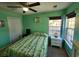 Bedroom featuring green walls, a ceiling fan, and a large window at 3108 Robins Nest Way, Myrtle Beach, SC 29579