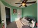 Sunlit bedroom with green walls, white trim, and a comfy sofa for relaxation at 3108 Robins Nest Way, Myrtle Beach, SC 29579