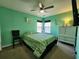 Bright bedroom featuring green walls, a ceiling fan, and windows with a view at 3108 Robins Nest Way, Myrtle Beach, SC 29579