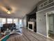 Cozy living room showcasing a fireplace, large windows, and neutral paint tones at 3108 Robins Nest Way, Myrtle Beach, SC 29579