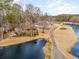 Aerial view of the home featuring mature trees, landscaping, and scenic golf course views at 3178 River Bluff Ln., Little River, SC 29566