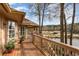 Inviting back deck with wood railing overlooking pond and golf course on a sunny day at 3178 River Bluff Ln., Little River, SC 29566