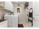 Functional laundry room with modern washer, dryer, and convenient storage cabinets at 3178 River Bluff Ln., Little River, SC 29566