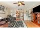 Living room with wood flooring, leather furniture and built-in storage at 3178 River Bluff Ln., Little River, SC 29566