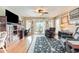 Living room with wood flooring, leather furniture and view to screened patio at 3178 River Bluff Ln., Little River, SC 29566