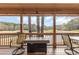 Outdoor living space on the covered porch, overlooking the lake and golf course at 3178 River Bluff Ln., Little River, SC 29566