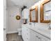 Bathroom with double sinks, white cabinets, decorative mirrors and neutral colors at 322 Crooked Oak Dr., Pawleys Island, SC 29585