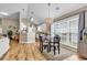 Cozy dining area with hardwood floors, chandelier, and large window overlooking the yard at 322 Crooked Oak Dr., Pawleys Island, SC 29585