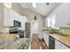 Well-lit kitchen with granite countertops, stainless appliances, and white cabinets at 322 Crooked Oak Dr., Pawleys Island, SC 29585