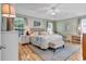 Spacious main bedroom features hardwood floors, ceiling fan, and ensuite bath at 322 Crooked Oak Dr., Pawleys Island, SC 29585