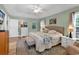 Main bedroom with a tray ceiling, ceiling fan, and access to the ensuite bath at 322 Crooked Oak Dr., Pawleys Island, SC 29585