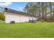 Backyard with green lawn, hot tub, and privacy fencing at 3471 Spivey St., Loris, SC 29569