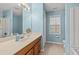 Bright bathroom features a vanity with mirror, a window, and a toilet at 3471 Spivey St., Loris, SC 29569