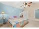 Bedroom with ceiling fan and quilt patterned bed spread. Two-tone wall paint and white trim at 3471 Spivey St., Loris, SC 29569