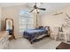 Charming bedroom with arched window, decorative Paris themed accents and a ceiling fan at 3471 Spivey St., Loris, SC 29569