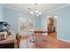 Comfortable dining area featuring laminate flooring, a charming chandelier, and bright, light blue walls at 3471 Spivey St., Loris, SC 29569