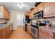 Classic kitchen features wooden cabinetry, stainless steel appliances and a view to the front door at 3471 Spivey St., Loris, SC 29569