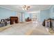 Bright, spacious living room with light blue walls and hardwood flooring transitioning to laminate at 3471 Spivey St., Loris, SC 29569