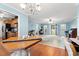 Open floor plan from dining area to living room, featuring laminate flooring and light blue walls at 3471 Spivey St., Loris, SC 29569